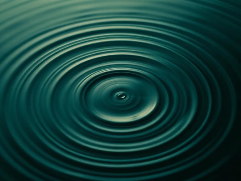 Concentric ripples spreading across still water